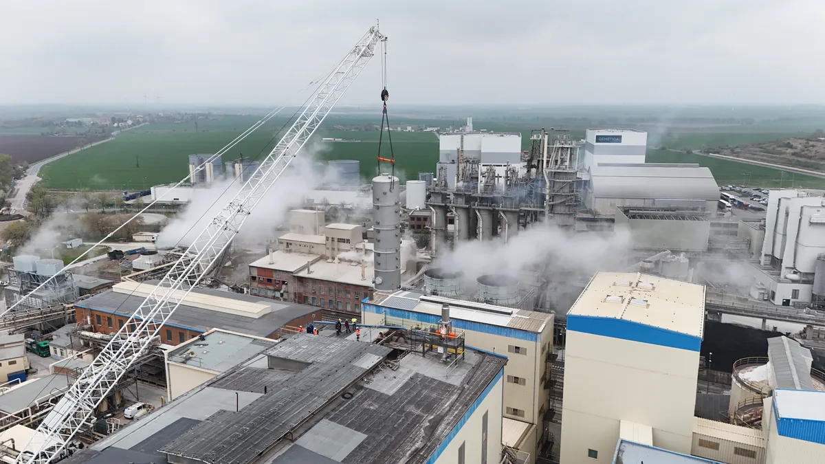 Aerial view of industrial plant assembly with crane lifting equipment